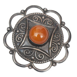 Silver brooch with amber