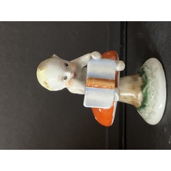 porcelain figurine boy on a mushroom