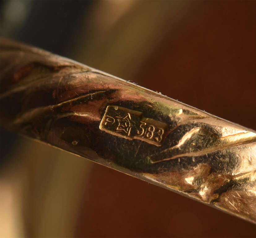 A gold ring with a large aventurine