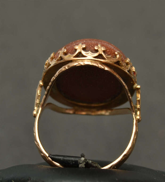 A gold ring with a large aventurine