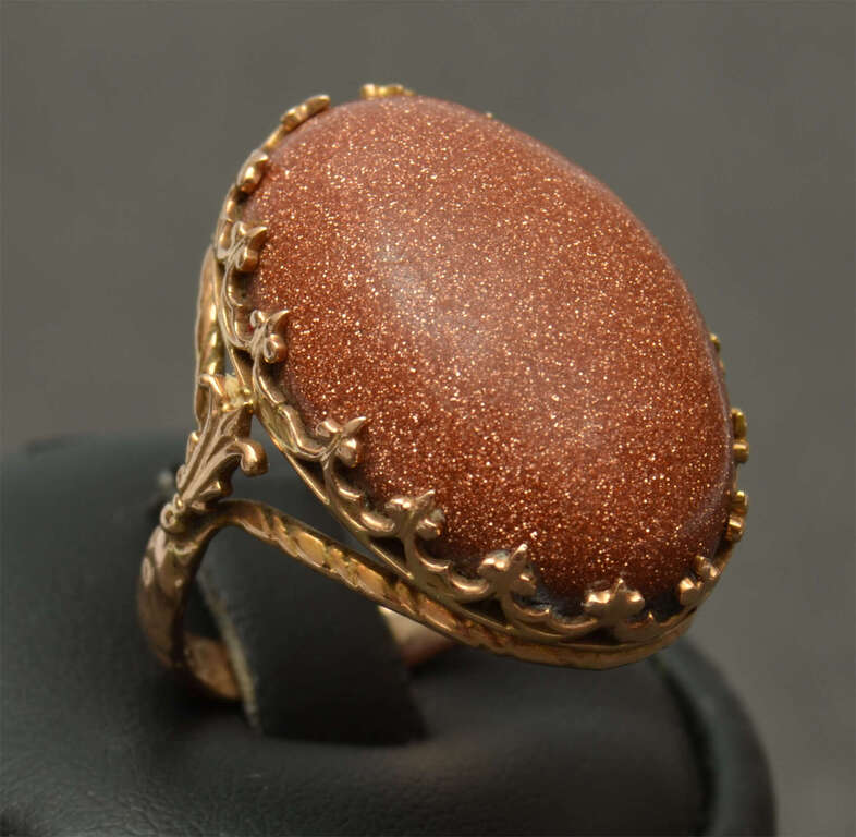 A gold ring with a large aventurine