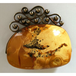 Amber brooch with metal finish