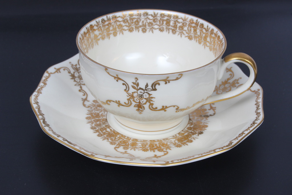 Painted porcelain cup with saucer