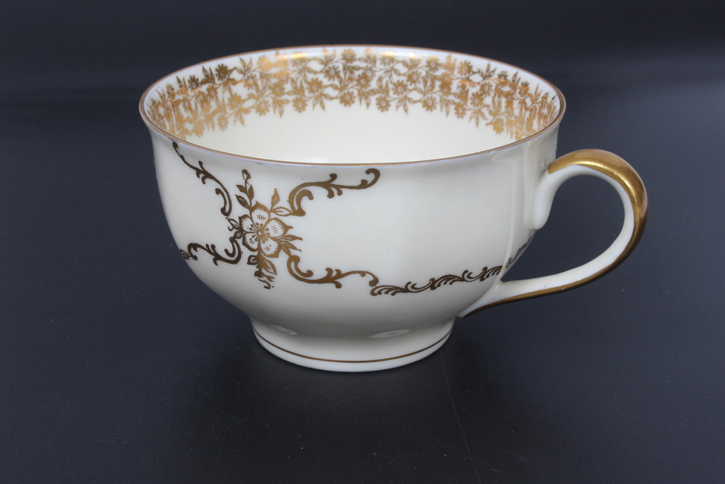 Painted porcelain cup with saucer