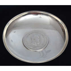 A silver dish with an embedded ruble coin of 1883