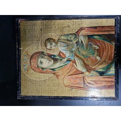 An ancient icon on a wooden base.