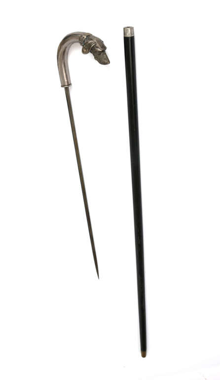 A wooden cane with a silver handle
