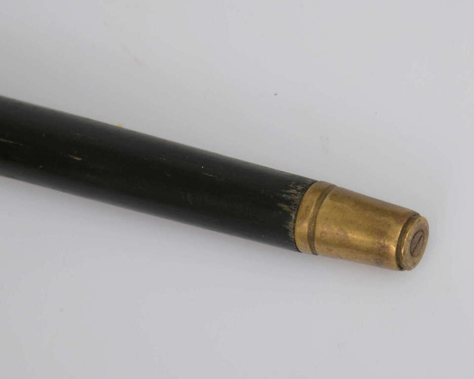 A wooden cane with a silver handle