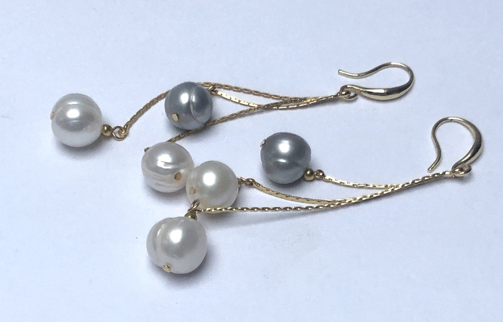 Long silver earrings with gold plating and freshwater pearls.