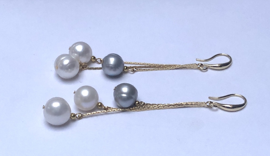 Long silver earrings with gold plating and freshwater pearls.