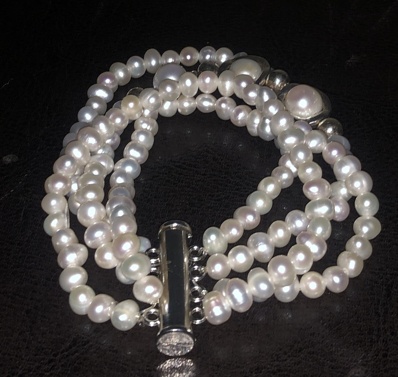 4-row bracelet with freshwater pearls and other metal elements.
