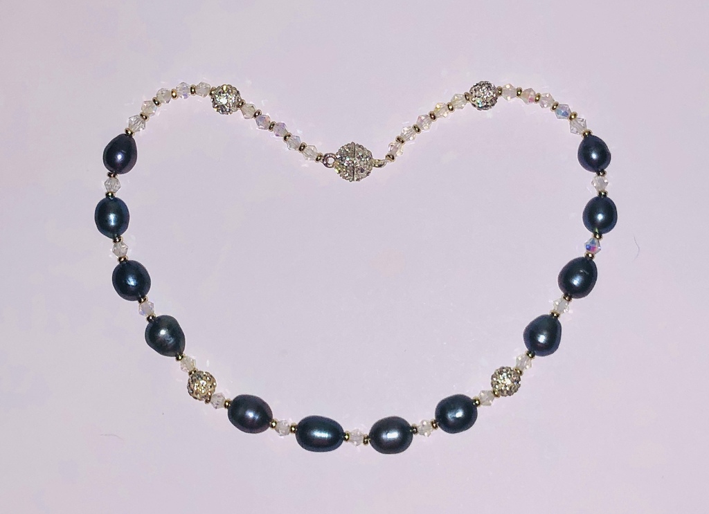 Necklace with dark freshwater pearls, crystals and zirconia elements.