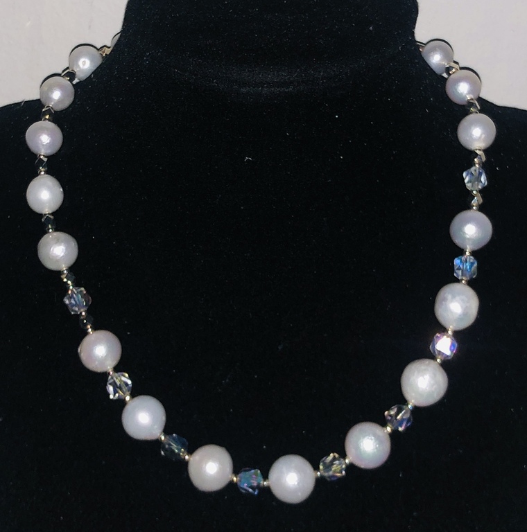 Necklace with white Edison freshwater pearls, Austrian crystals and a magnetic clasp with cubic zirconias.