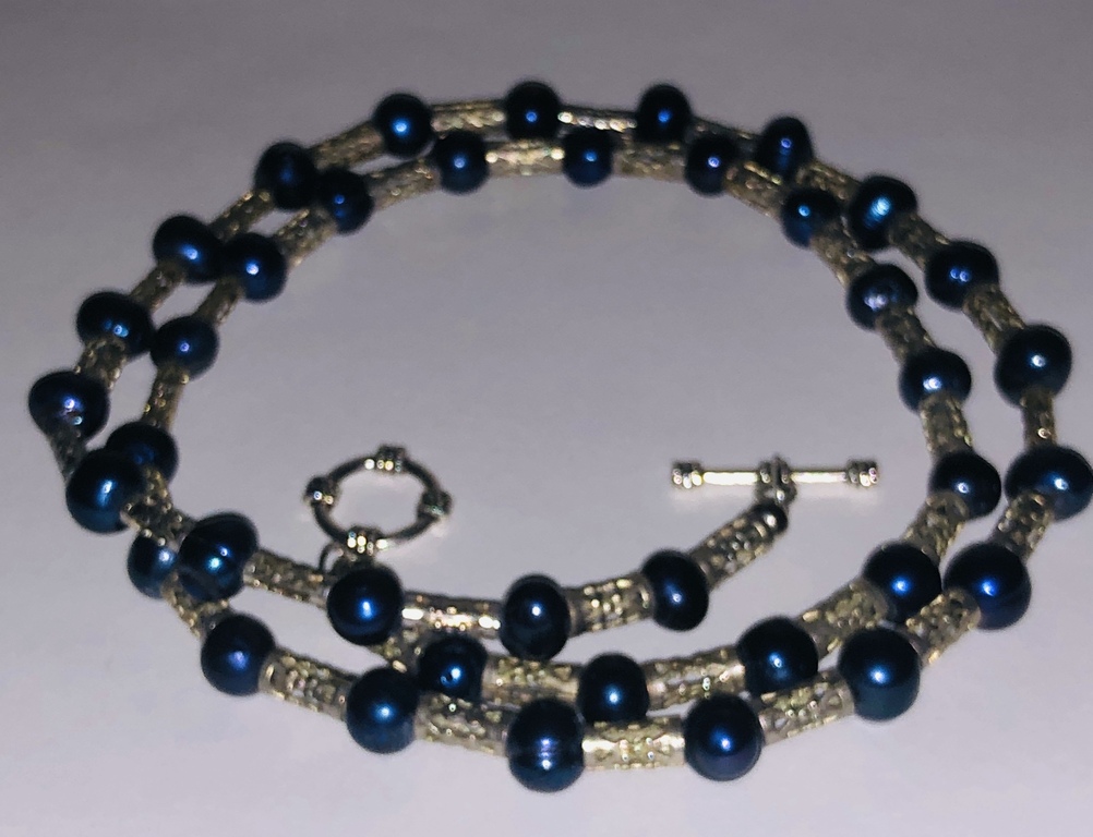 Beads with blue freshwater pearls and other metal elements.