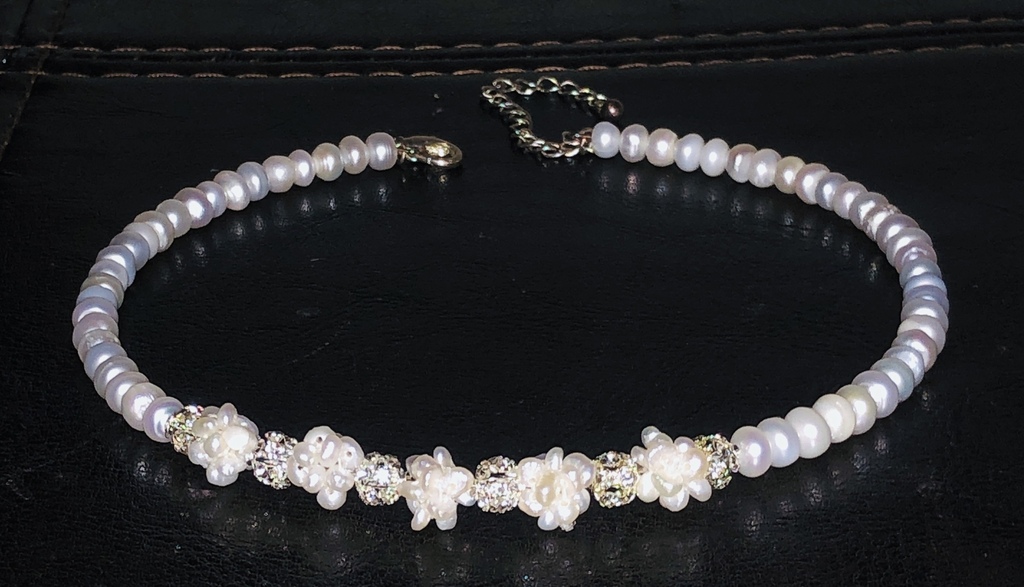 Necklace with white freshwater pearls and other elements.