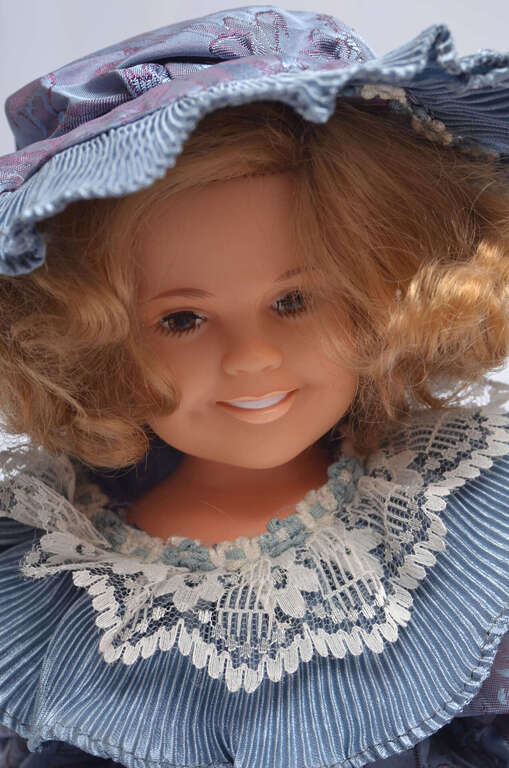 Vintage doll in a blue dress
