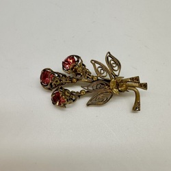 Pre-war filigree brooch for a hat or neckerchief. Garnet rhinestones. 20 years 