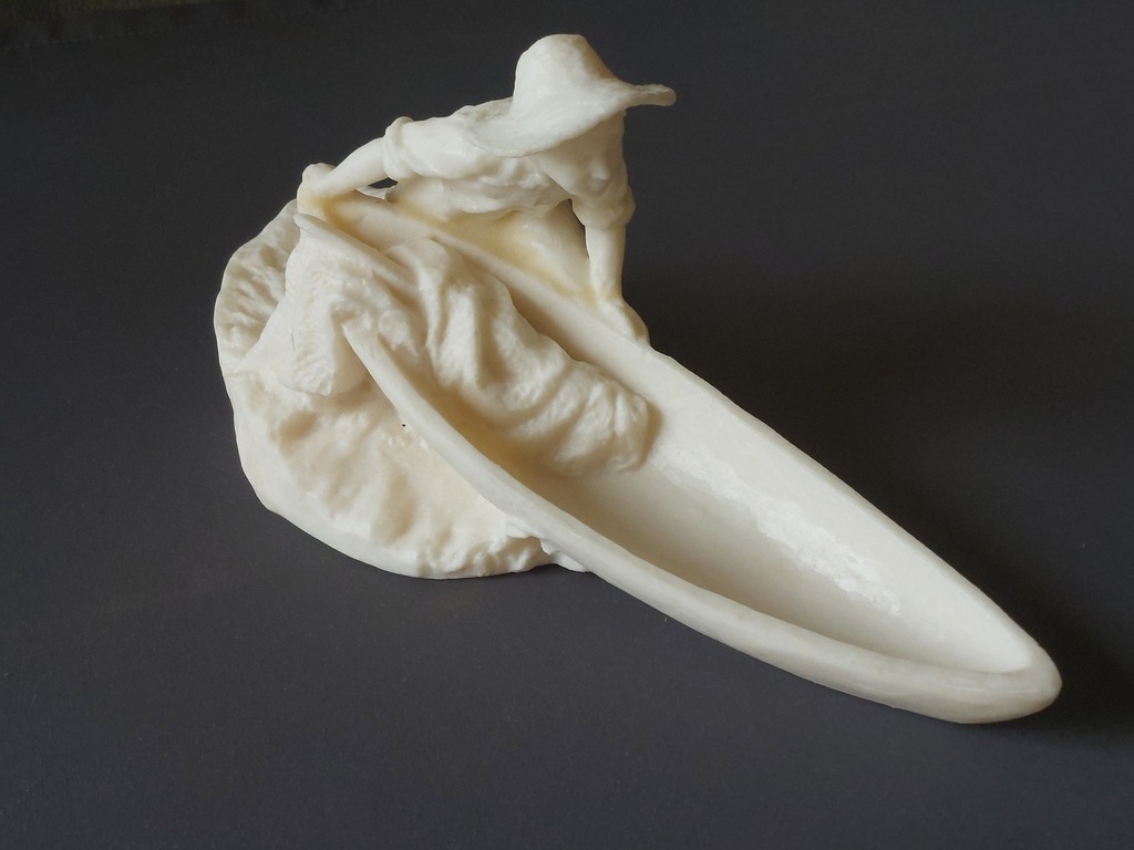 Bakelite figurine of a young fisherman with a boat