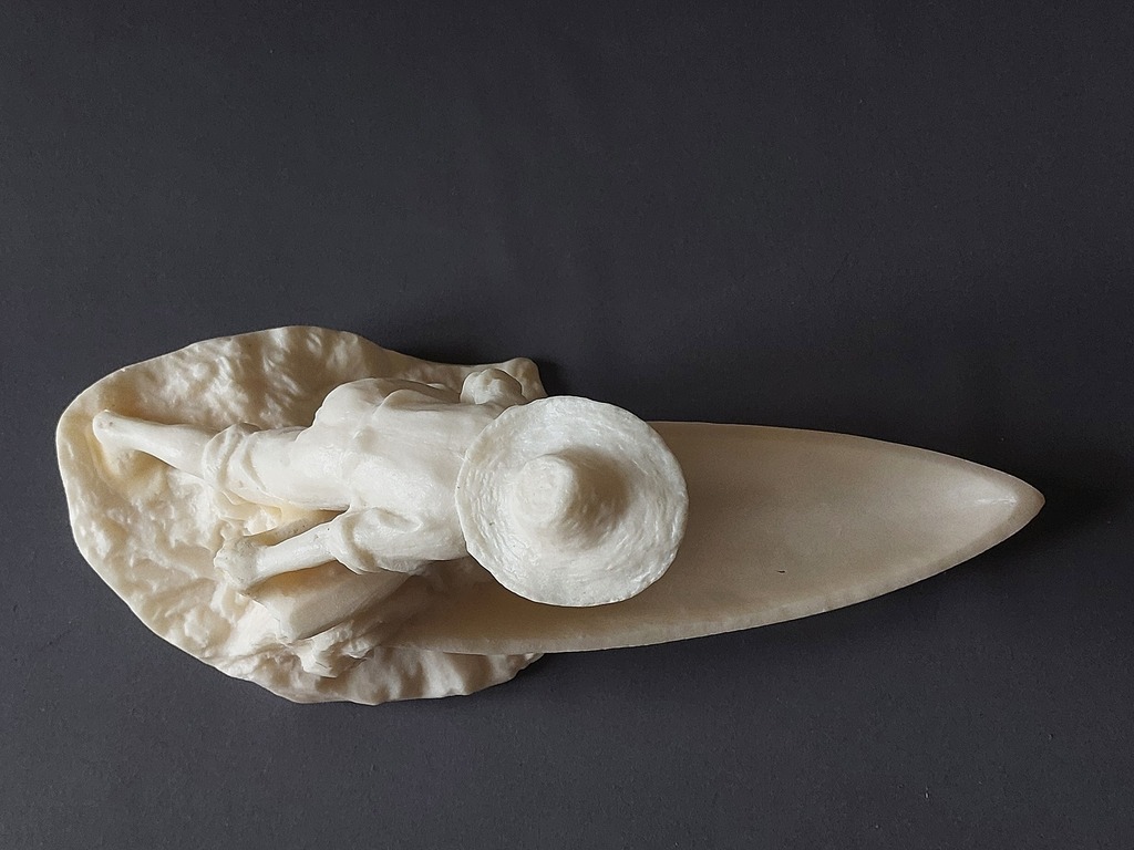 Bakelite figurine of a young fisherman with a boat