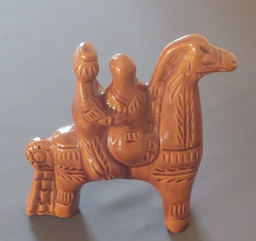 Vintage decorative sculpture of a Cossack with a Cossack woman on a horse.
