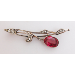 Silver brooch with red stone