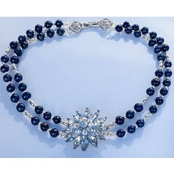 Necklace with dark blue freshwater pearls and silver elements with a pendant. 