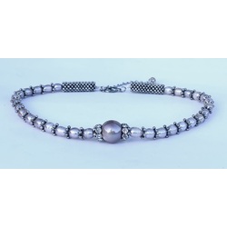 Necklace with lavender freshwater pearls and metal elements.