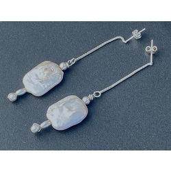 Silver earrings with natural flat shaped pearls.0