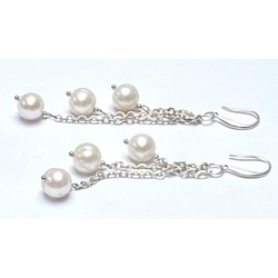 Long silver earrings with freshwater pearls. 