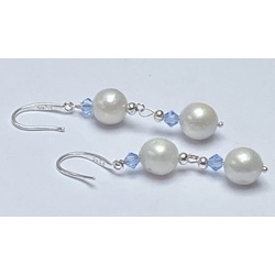 Silver earrings with Edison freshwater pearls and light blue crystals. 