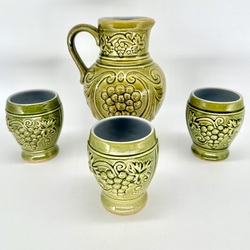 A jug and three wine glasses made of glazed ceramics. Poured ceramics and handmade. Konakovo