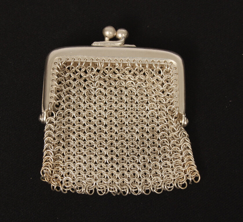 A small silver-plated metal purse