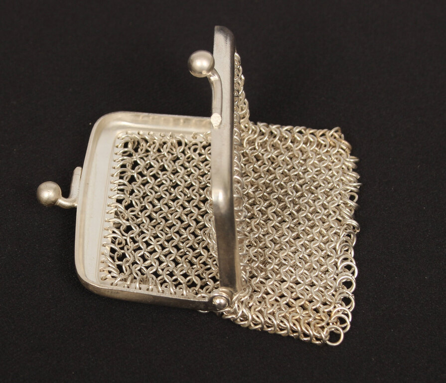 A small silver-plated metal purse