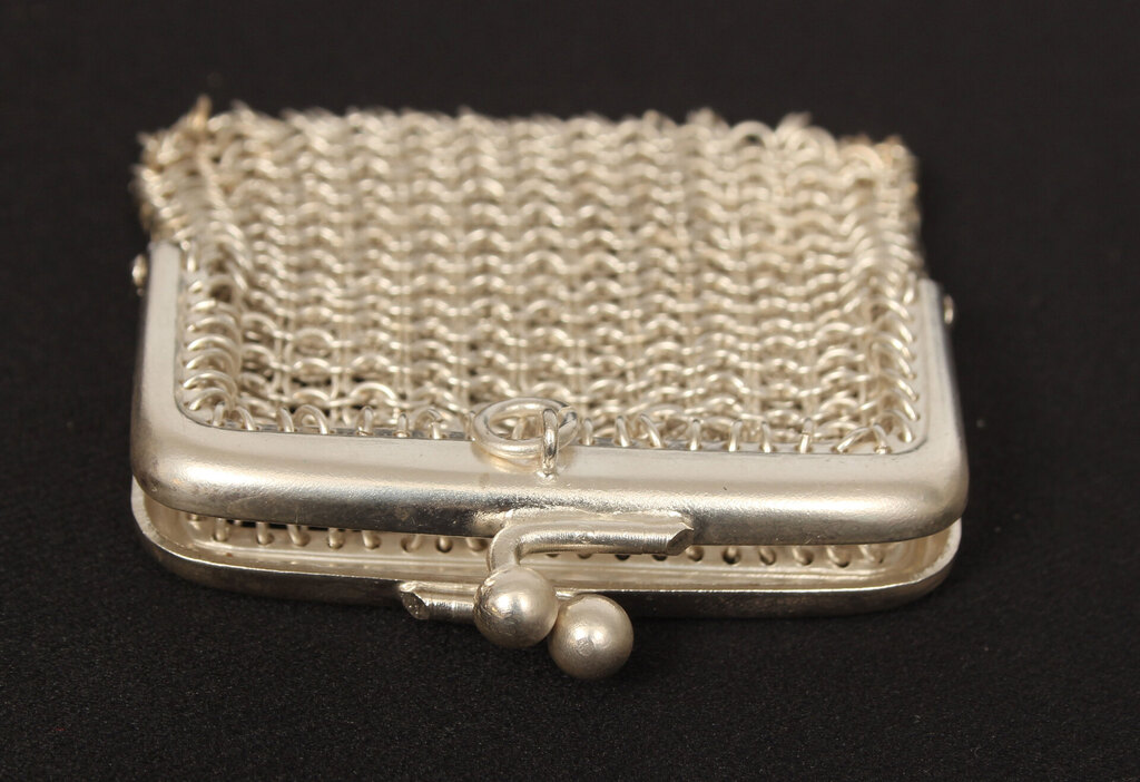 A small silver-plated metal purse