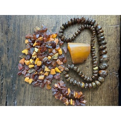 A piece of amber, an amber bracelet, amber beads and a lot of small amber with holes for a thread