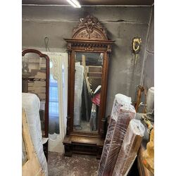 A mahogany mirror with an ornate carved cornice