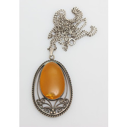 Amber pendant in metal frame with silver chain