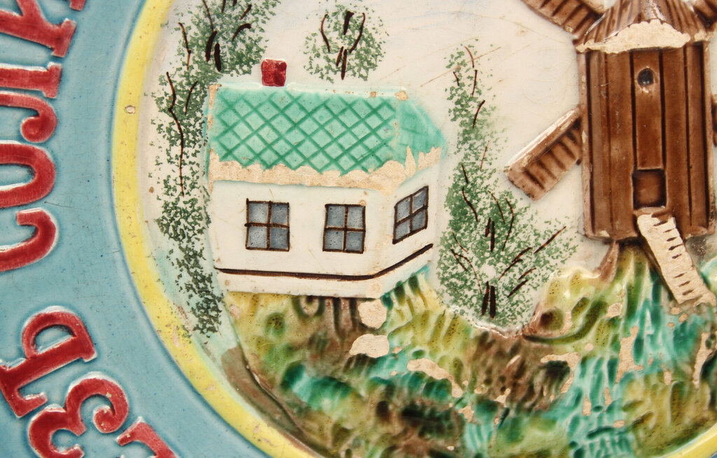 Faience plate with a painting (with a defect)