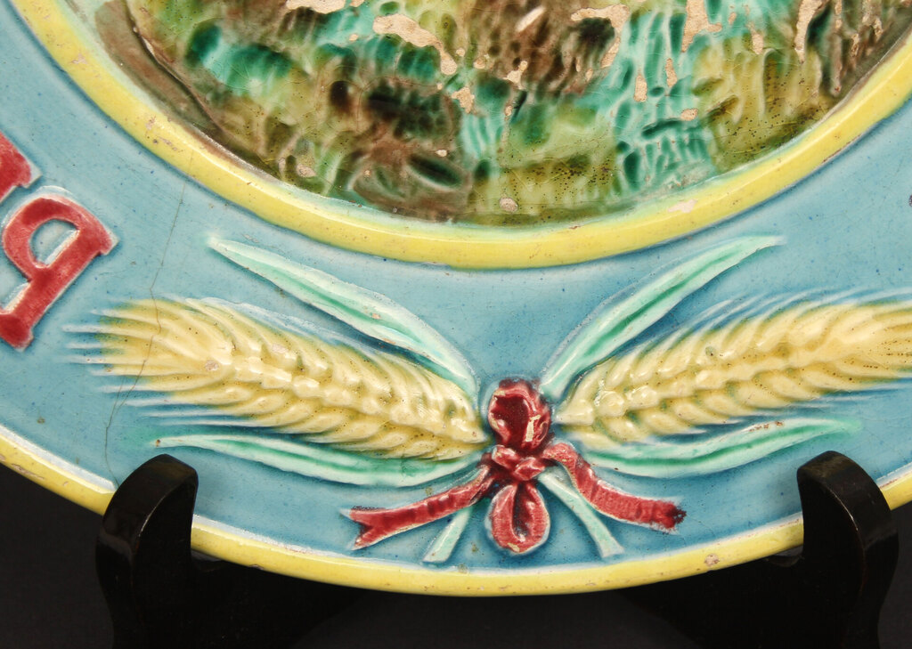 Faience plate with a painting (with a defect)