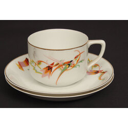 A porcelain cup and two saucers