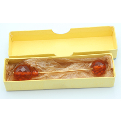 Amber hair clip with metal finish in original packaging