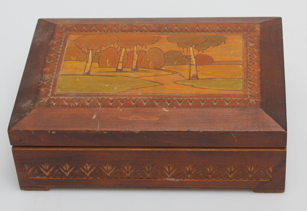 A wooden casket with a painting