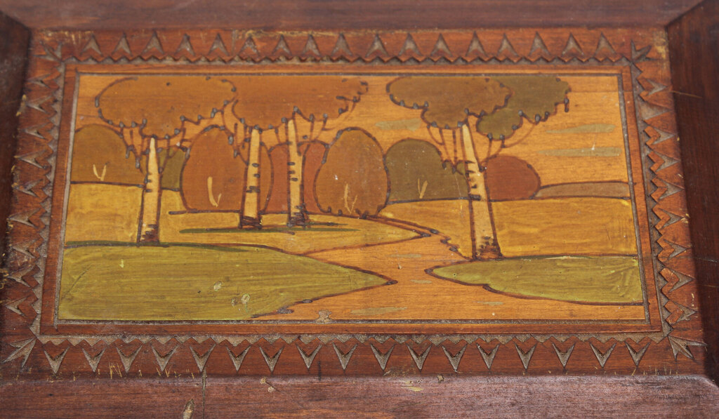 A wooden casket with a painting