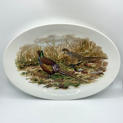 Large porcelain plate with a decor in the form of a pair of pheasants in a field.