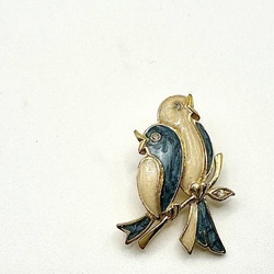 Vintage brooch of a bird on a branch. Enamel with a rhinestone 