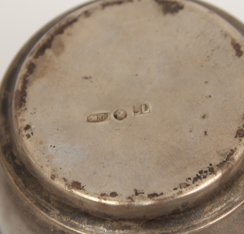 Silver cup with saucer and spoon